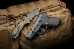 small modern pistol and penknife